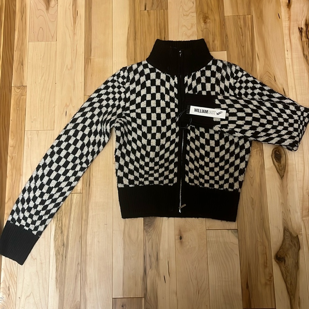 Women/juniors size XS,  zip up sweater, with tags. Never worn, great condition.